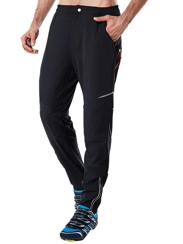 Man wearing lightweight men's sweatpants with reflective stripes, featuring elastic waistband and moisture-wicking polyester fabric.